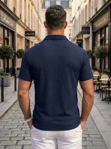 Back view of men's navy blue textured polo shirt in a stylish European street setting