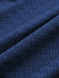 Close-up detail of navy blue men's polo shirt showing intricate jacquard woven texture