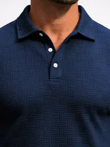 Close-up of blue men's jacquard polo shirt showing fabric texture and collar detail