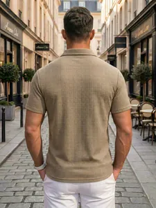 Back view of a men's khaki textured knit polo shirt captured in a European street setting