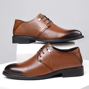 Elegant brown men's perforated leather dress shoes on minimalist white podiums