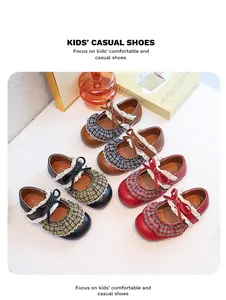 Detailed view of vintage Mary Jane shoes for girls with lace and plaid ruffle accents