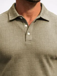 Close-up detail of a men's polo shirt showing intricate jacquard woven texture