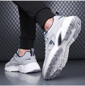 Side and sole detail of men's breathable grey mesh sports sneakers with navy blue accents