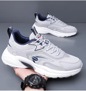 Close-up detail of men's grey breathable mesh sneakers featuring chunky white soles