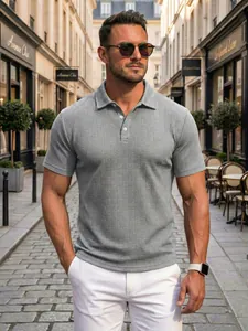 Stylish men's grey polo shirt with jacquard texture shown in a classic European street setting.