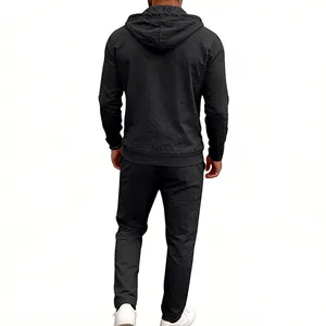 Back view of men's loose black linen hooded shirt and matching trousers set