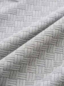 High-resolution macro detail showing the grey jacquard knit fabric texture of a polo shirt