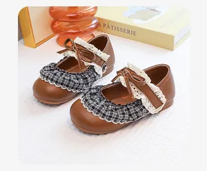Detailed view of girls vintage Mary Jane shoes with plaid ruffles and lace trim