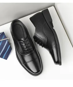 Macro view of black perforated cap-toe business dress shoes for men in British style