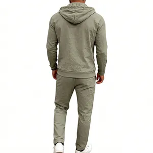 Back view of men's loose olive green linen hooded shirt and matching pants set.