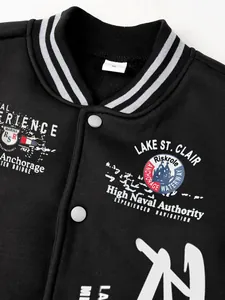 Detail view of a men's black varsity jacket featuring nautical prints and striped collar.