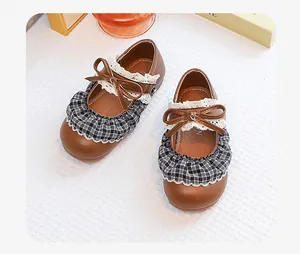 High-quality detail view of brown retro Mary Jane shoes for girls with plaid ruffles and bow