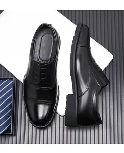 Detail view of premium black cap-toe business oxfords on a minimalist background