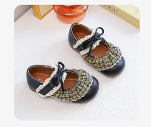 Detailed view of vintage Mary Jane princess shoes with plaid and lace accents.
