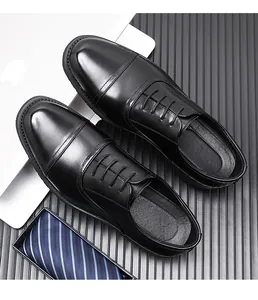 Top view of black formal leather cap toe shoes for men in a professional business setting