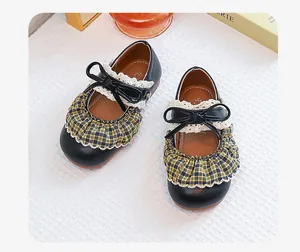Vintage plaid girls Mary Jane shoes with black bow and lace trim detail for kids.
