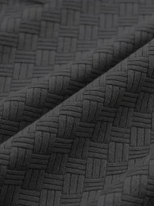 Detailed macro shot of dark grey jacquard woven fabric for men's casual polo shirt.