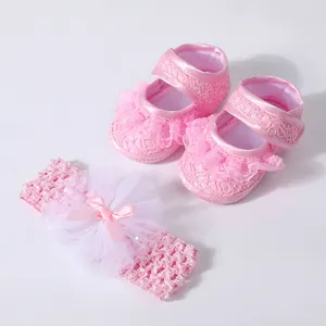 Set of pink lace infant walker shoes and a matching floral tulle flower headband.