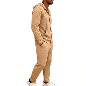 Side view of a man wearing a khaki linen hooded shirt and matching pants set