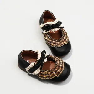 Vintage black Mary Jane shoes for girls featuring plaid ruffle and elegant lace bow detail.