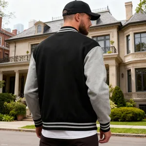 Men's classic black and grey varsity jacket with striped trim, back view outdoor