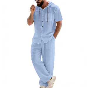 Full-length view of men's casual light blue hooded short sleeve shirt and trouser set.