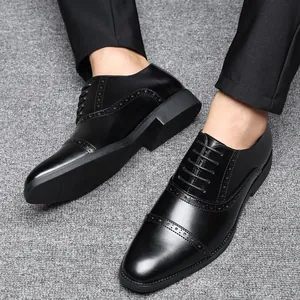 Vista detallada de zapatos clásicos de vestir para hombre en piel negra estilo brogue