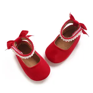 Red velvet baby girl Mary Jane shoes with pearl trim and ribbon bow decoration.
