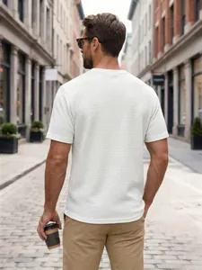 Rear view of man wearing a white waffle knit short sleeve t-shirt in city street
