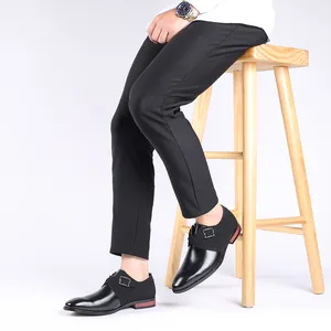 Detailed view of men's black pointed-toe business shoes with decorative buckle strap