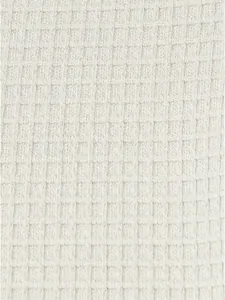 Detailed macro view of the premium cream waffle knit fabric on this men's Henley shirt