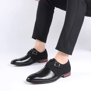 Close-up detail of black formal monk strap shoes featuring leather and suede contrast textures