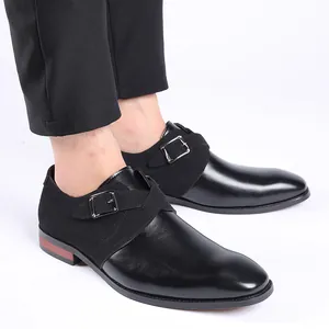 Close-up of black men's formal shoes with silver buckle strap and mixed material texture