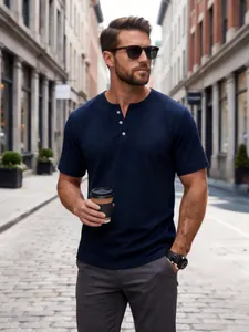 Detail shot of navy blue waffle-knit Henley shirt on male model in urban setting.
