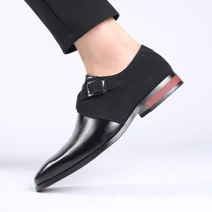 Detailed macro view of black patchwork leather monk strap dress shoes with pointed toe