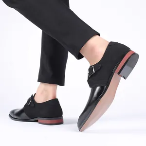 Detail of stylish black monk strap dress shoes with pointed toe and mixed leather finish