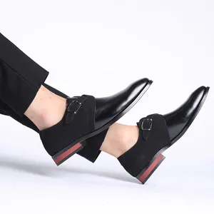 Detailed view of men's black leather and suede monk strap shoes with a pointed toe