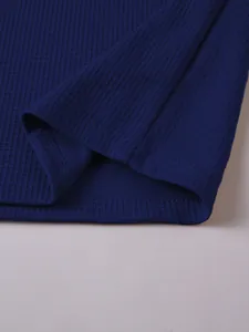 Close-up detail of navy blue waffle knit fabric showing premium stitching and texture