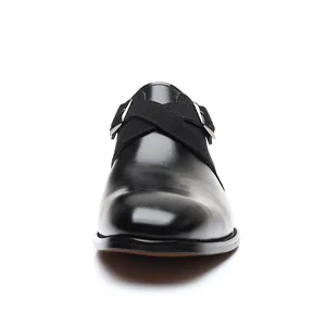 Front view of stylish black leather business dress shoes with suede cross strap detail
