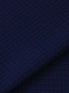 Detailed macro view of dark blue waffle knit fabric for breathable men's t-shirt