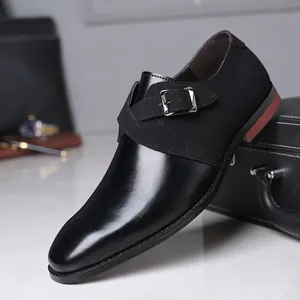 Detailed view of men's monk strap dress shoe with leather and suede patchwork design