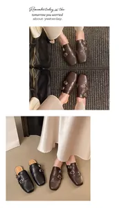 Λεπτομερής άποψη των vintage brogue mules με αγκράφες και διακοσμητικά σχέδια