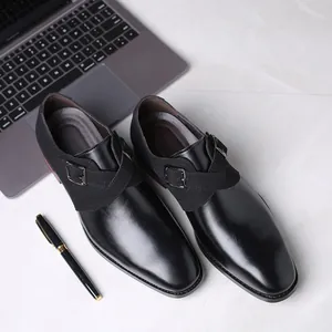 High-angle detail view of elegant black men's pointed-toe business leather monk strap shoes