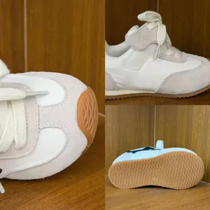Detail view of children's non-slip trainee shoes with suede and fabric textures