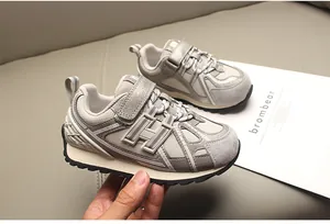 Detalle de zapatillas infantiles transpirables con logo H y malla técnica.
