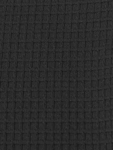 Macro detail of breathable black waffle knit fabric for men's casual Henley shirts
