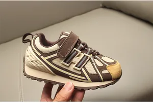 Primer plano de zapatilla retro para niños con malla y marca lateral del logo H