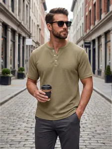Lifestyle detail of khaki waffle-knit Henley shirt worn by a man on a city street