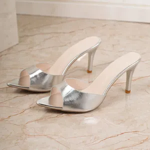 Elegant silver metallic stiletto slides with square peep toe design for fashionable women.